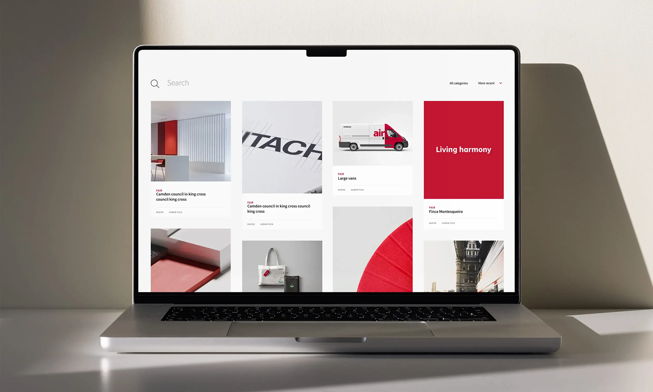 Blonde woman comfortably seated on a sofa while enjoying a cup of coffee and leisurely browsing web content on a tablet.