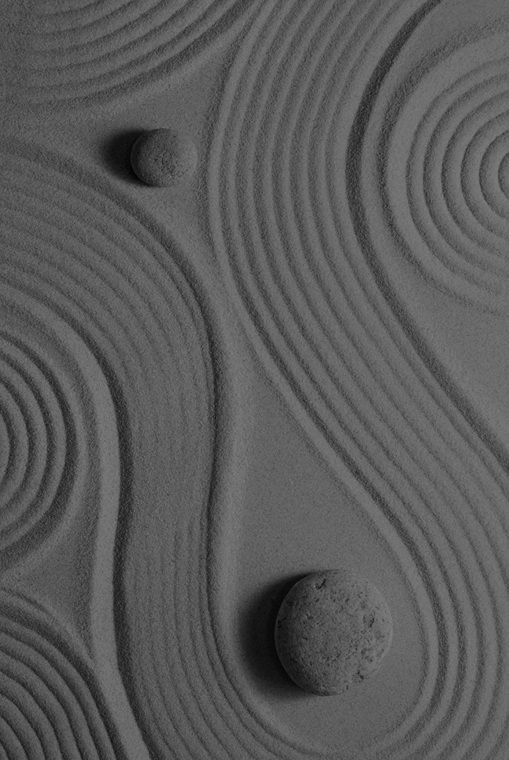Sinuous shapes in the sand abstractly resembling a system.